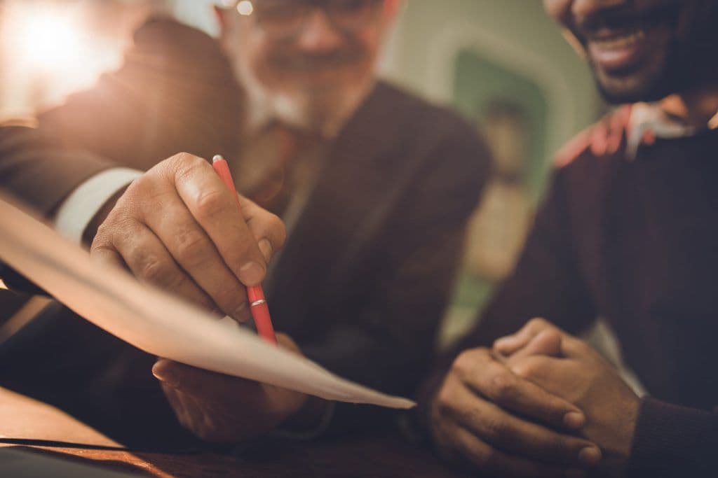 banker pointing at paper