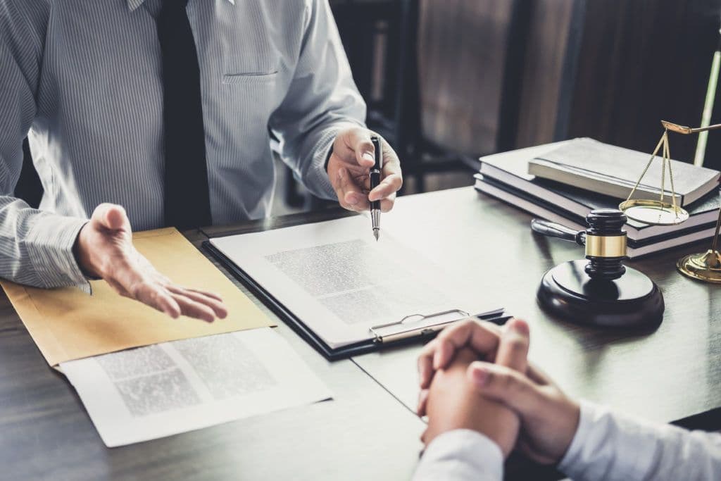 man consulting another man at desk